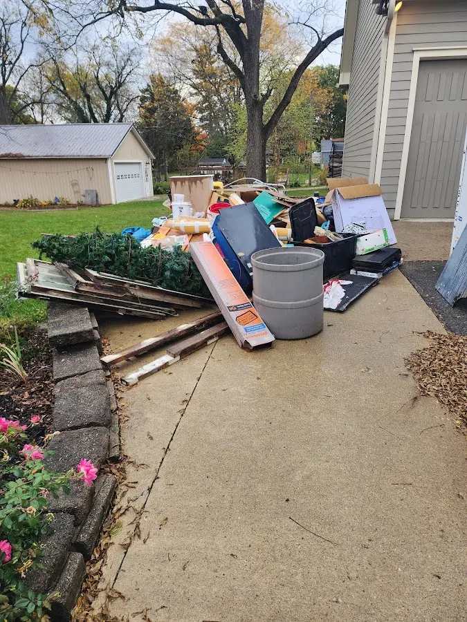 Dumpster being loaded with debris for Estate Cleanout Dumpster Rental in Pleasant Hill
